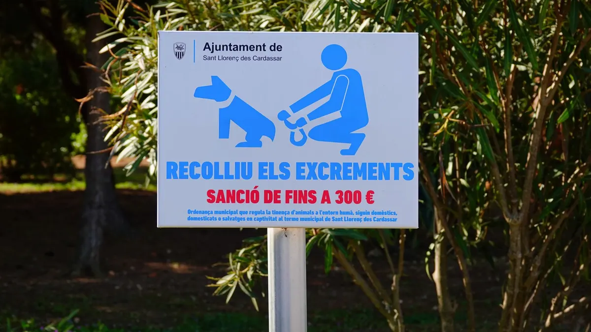 Sign urging dog owners to clean up waste in Sant Llorenç des Cardassar, Spain.